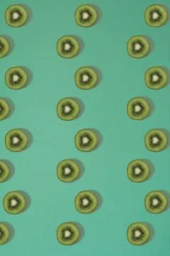 Pattern of kiwi. Top view of the sliced kiwi on blue background. Minimal flat Stock Photos