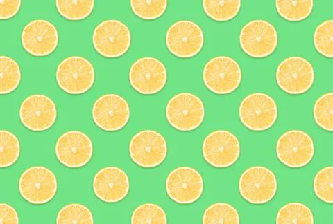 Pattern of lemon slices on light green background Stock Photos