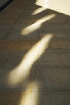 Pattern of light and shadow on tiled floor Stock Photos