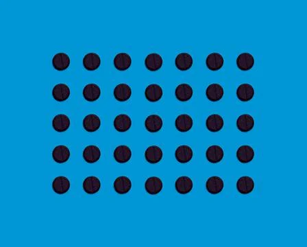 The pattern is made of black pharmaceutical tablets on a blue background. Med Stock Photos