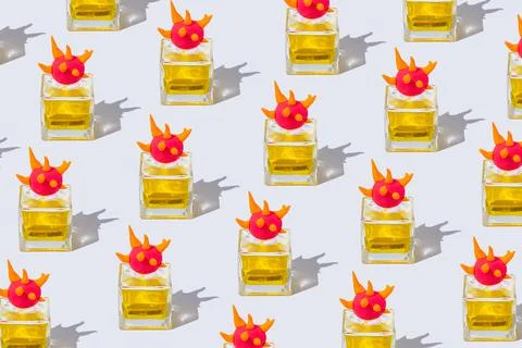 Pattern made of a bottle of yellow perfume decorated with a cap of shaped mul Foto stock