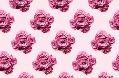 Pattern made from bouquets of rose flowers on a pink pastel background Stock Photos