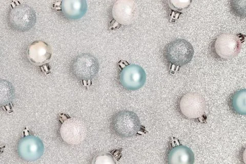 Pattern made of Christmas baubles on a silver textured background. 스톡 사진