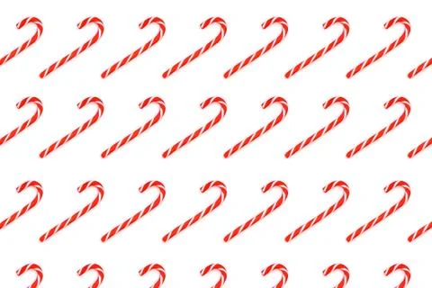Pattern made from Christmas candy canes isolated on white. Stock Photos