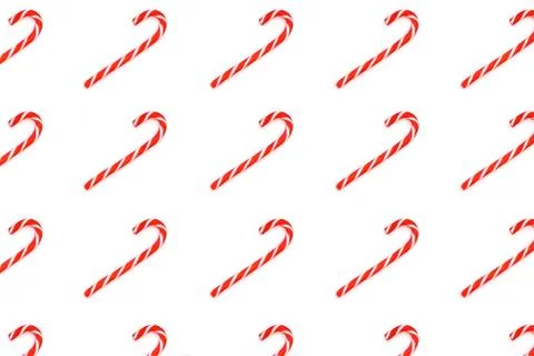 Pattern made from Christmas candy canes isolated on white. Stock Photos