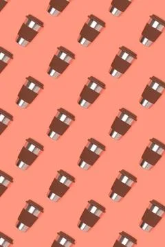Pattern made of coffee cup on a coral background. Stock Photos