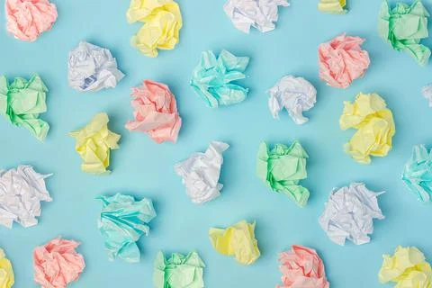 Pattern made with colored crumpled paper balls on blue background, texture. T Stock-Fotos