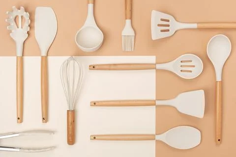 Pattern made from cooking utensil set. Silicone kitchen tools with wooden han Stock Photos