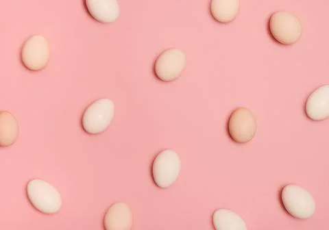 Pattern made of eggs on pastel pink background. Minimal food concept. Stock Photos