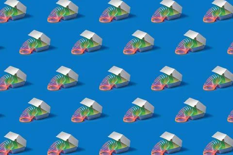 Pattern made of Flexible rainbow spring in a silver food container. Patter... Stock Photos