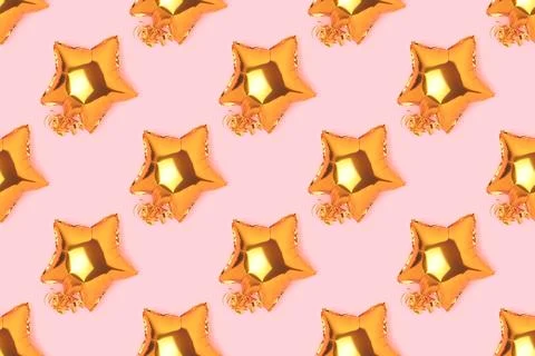 Pattern made of golden inflatable foil balloons in a star shape. Stock Photos