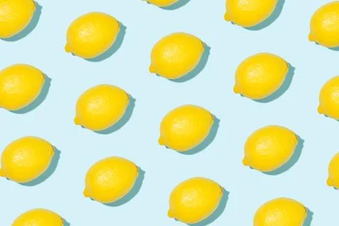 Pattern made of lemons on blue background. Stock Photos