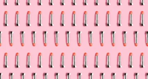 Pattern made from lipsticks on pink background. Stock Photos