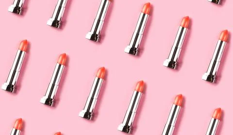 Pattern made from lipsticks on pink background. Stock Photos