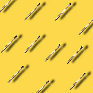 Pattern made with many Toothbrush on yellow backdrop with trendy summer shado Stock Photos