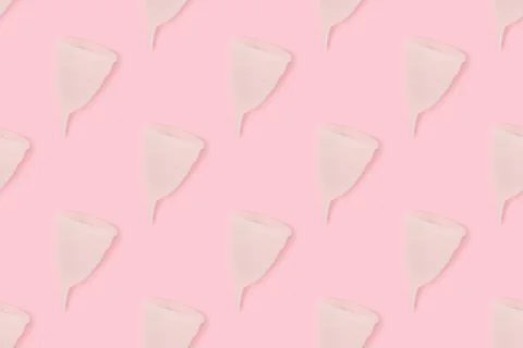 Pattern made of menstrual cup on a pink background. 写真素材