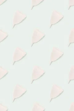 Pattern made of menstrual cups on a blue background. 写真素材