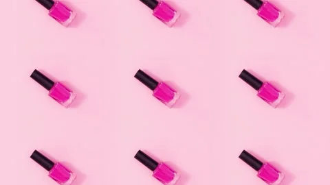 Pattern made of nail polishes bottles rotate and change color. Stop motion Stock Footage 155054062