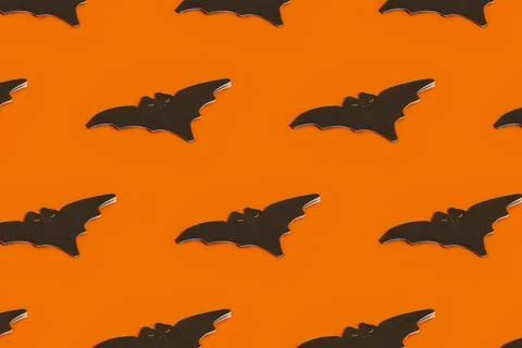 Pattern made with napkin in the shape of a bat on an orange background with copy 스톡 사진