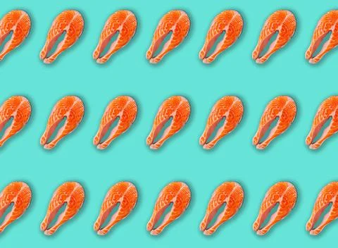 Pattern made of raw fresh fish salmon steak top view on blue clean background 스톡 사진