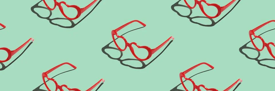Pattern made with red heart shaped sunglasses on pastel color background Stock Photos