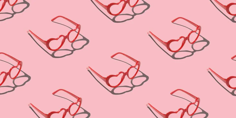 Pattern made with red heart shaped sunglasses on pastel color background Stock Photos