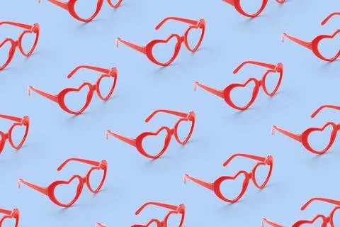 Pattern made with red heart shaped sunglasses on pastel color background Stock Photos