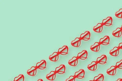 Pattern made with red heart shaped sunglasses on pastel color background Stock Photos