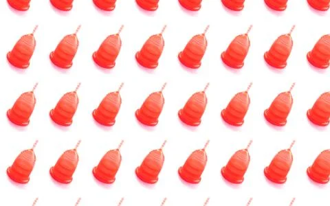Pattern made from red menstrual cup on white background. Stock Photos