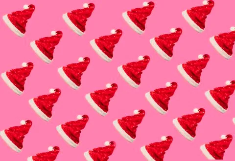 Pattern made of red Santa Claus hat on pink background. Christmas concept. Fl 写真素材