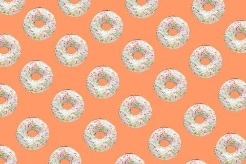 Pattern made of ring donuts Pattern made of ring donuts with white glaze a... Stock Photos