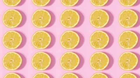 Pattern made of sliced citrus lemons rotating on pink background. Stop motion Video stock 153180150