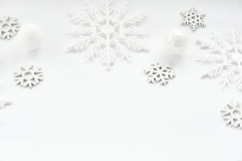 Pattern made of white balls and snowflakes on white background. Stock Photos