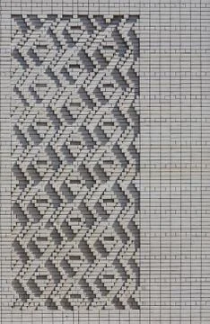 A pattern made of white bricks in the form of diamond shapes. Decoration of t Stock Photos