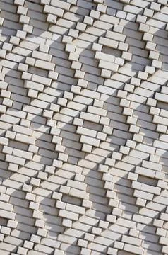 A pattern made of white bricks in the form of diamond shapes. Decoration of t Stock Photos