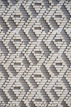 A pattern made of white bricks in the form of diamond shapes. Decoration of t Stock Photos