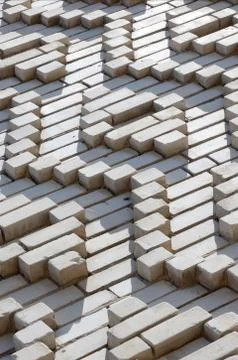 A pattern made of white bricks in the form of diamond shapes. Decoration of t Stock Photos