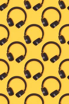 Pattern made of wireless headphones on a yellow background Stock Photos