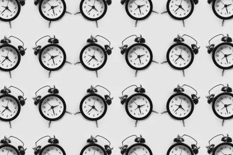 Pattern of many black alarm clocks isolated on white background. Stock Illustration