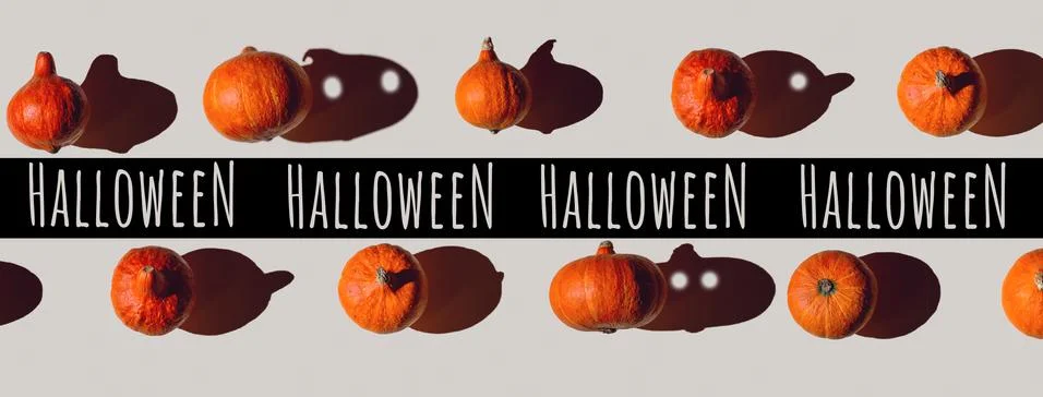 Pattern of many different pumpkins with a hard shadow on a gray background. H 写真素材