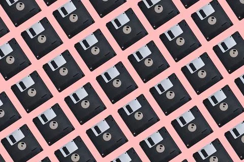 Pattern with many floppy disks on pink background. Retro computer diskette Stock Photos