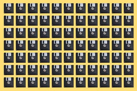 Pattern with many floppy disks on yellow background. Retro computer diskette Stock Photos