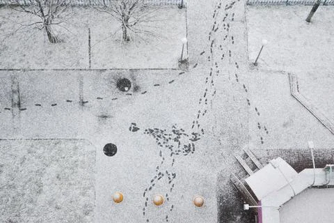 Pattern of many footprints in fresh snow on an urban street 스톡 사진
