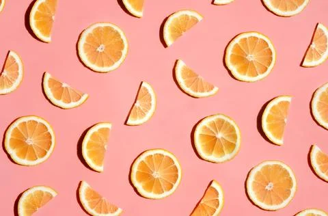 Pattern of many sliced lemons and oranges on a trendy bright pink background Stock Photos