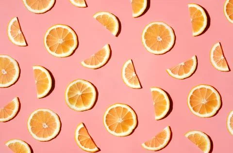 Pattern of many sliced lemons and oranges on a trendy bright pink background Stock Photos