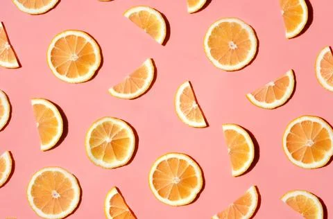 Pattern of many sliced lemons and oranges on a trendy bright pink background Stock Photos