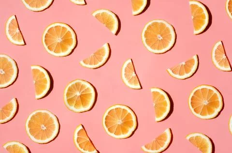 Pattern of many sliced lemons and oranges on a trendy bright pink background Stock Photos