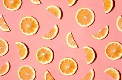 Pattern of many sliced lemons and oranges on a trendy bright pink background Stock Photos