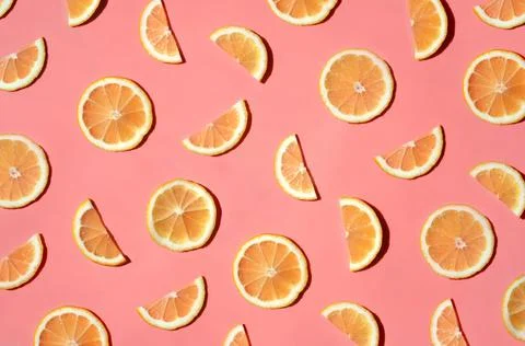 Pattern of many sliced lemons and oranges on a trendy bright pink background Stock Photos