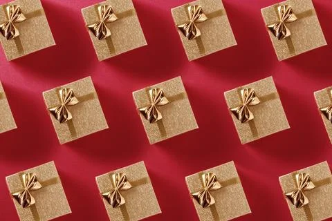 Pattern of many small golden gift boxes on red background Stock Photos